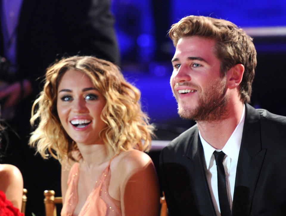 Actress/singer Miley Cyrus (L) and actor Liam Hemsworth in the audience during Muhammad Ali's Celebrity Fight Night XVIII held at JW Marriott Desert Ridge Resort &amp; Spa on March 24, 2012 in Phoenix, Arizona.&nbsp;