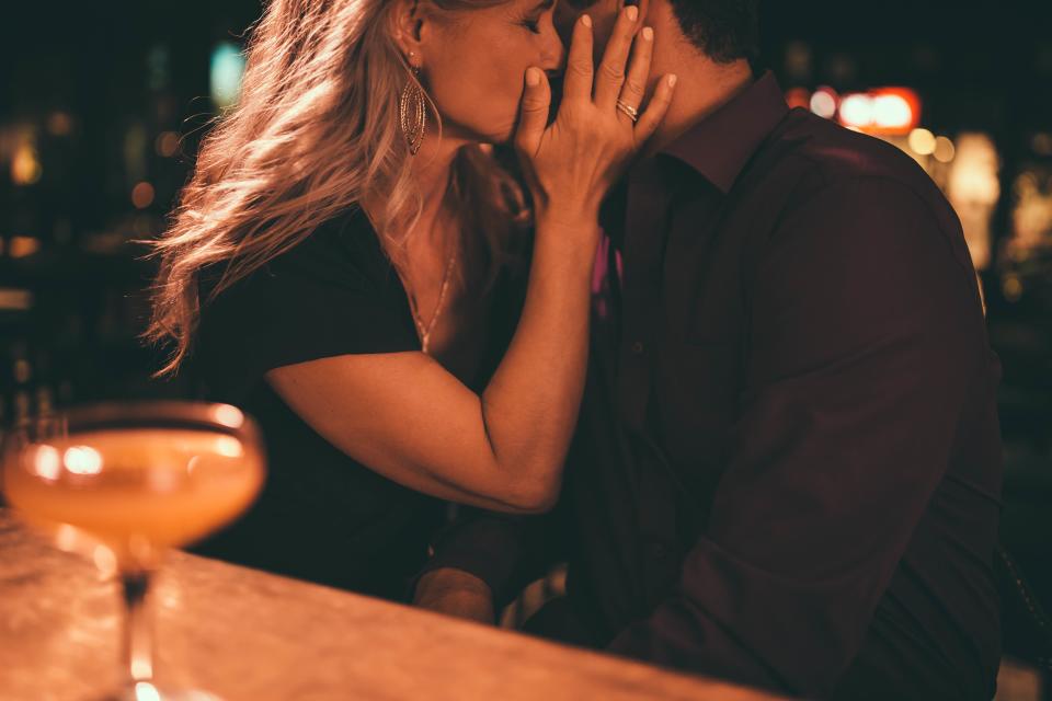 Couple kissing in bar