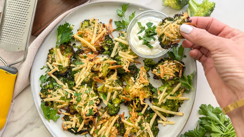 dipping a broccoli piece