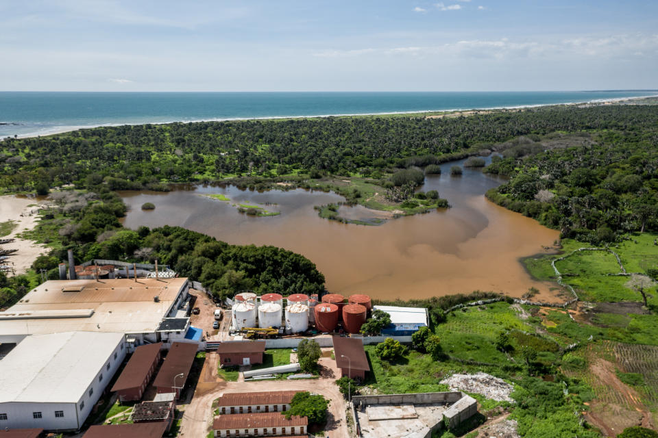 Aerial shot of foliage, waterways and a factory.