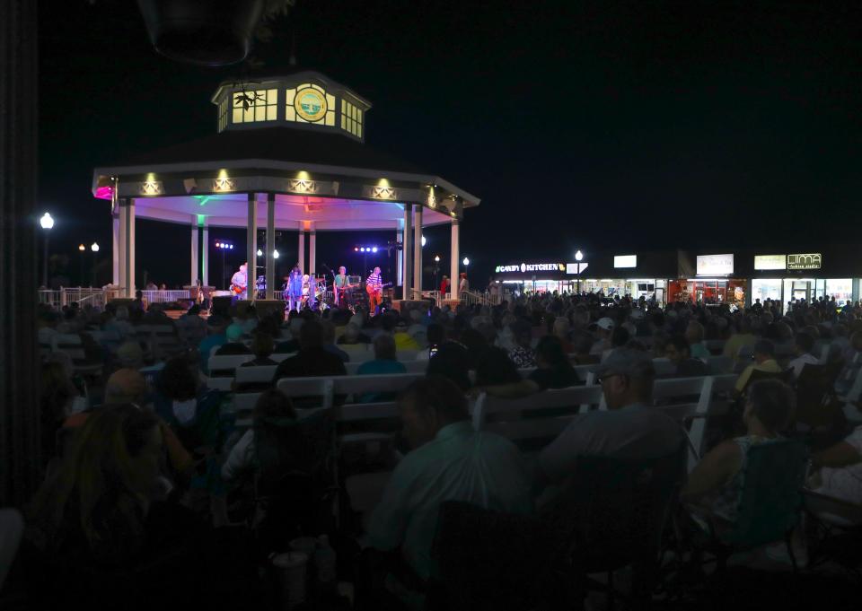 Hundreds of people crowd the bandstand for an evening concert in Rehoboth Beach as crowds descended on the Delaware beaches, Saturday, August 21, 2022.