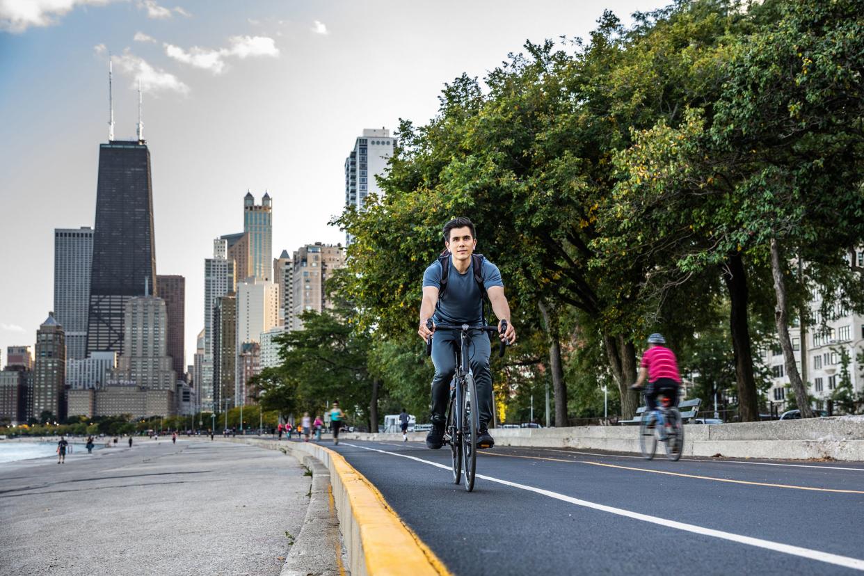 young man cycling in Chicago by Michigan lake