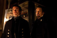 In this film publicity image released by Relativity Media, Luke Evans portrays Detective Fields , left, and John Cusack portrays Edgar Allan Poe in a scene from the gothic thriller "The Raven." (AP Photo/Relativity Media, Larry Horricks)