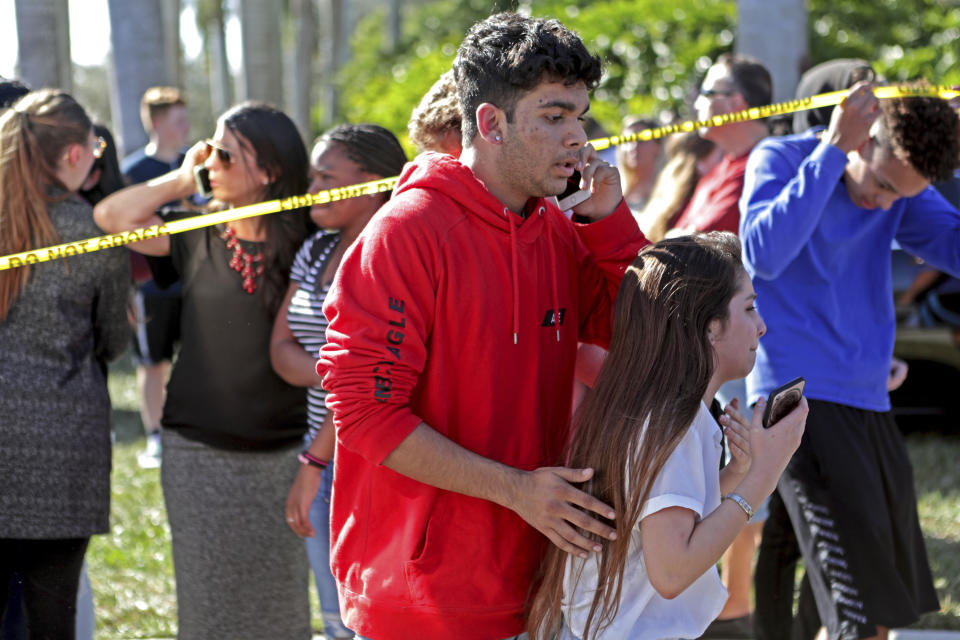 <p>Students released from a lockdown are overcome with emotion following following a shooting at Marjory Stoneman Douglas High School in Parkland, Fla., Feb. 14, 2018. (Photo: John McCall/South Florida Sun-Sentinel via AP) </p>