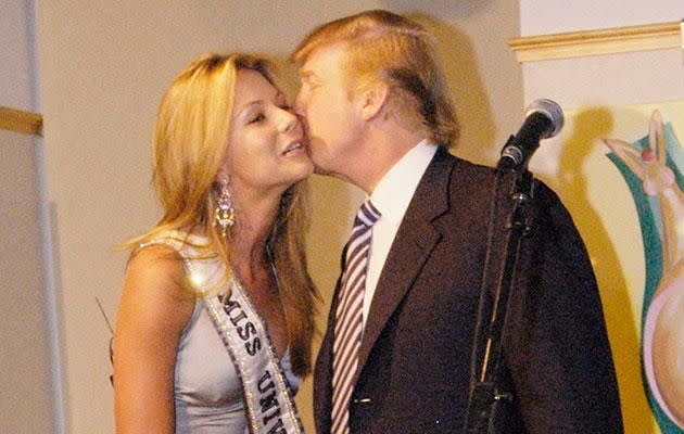 Trump kisses Jen during the Miss Universe 2004 pageant. Source: Getty