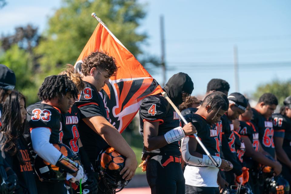 A moment of silence is held at Linden High School's Sept. 24 football game against Perth Amboy, just days after Linden player Xavier McClain, 16, died after suffering an apparent head injury in a game on Sept. 9.