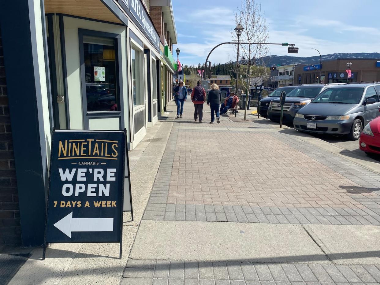 An open sign at a Whitehorse business on Friday. The Yukon government is pausing a program designed to fill labour shortages by expediting the permanent residency process for foreign nationals. (Gabrielle Plonka/CBC - image credit)