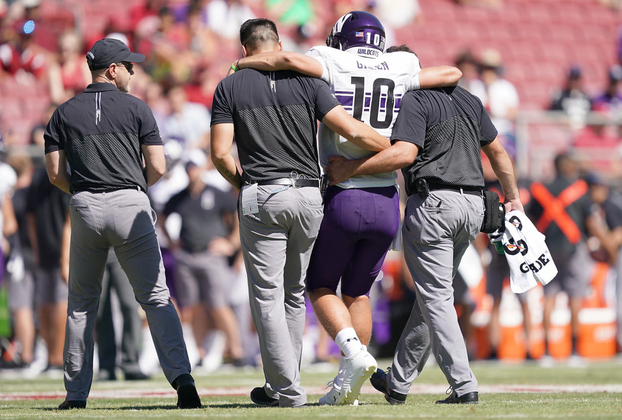 PALO ALTO, CA - AUGUST 31:  TJ Green #10 of the Northwestern Wildcats is helped off the field after he was injured against the Stanford Cardinal during the third quarter of an NCAA football game at Stanford Stadium on August 31, 2019 in Palo Alto, California. Stanford won the game 17-7.  (Photo by Thearon W. Henderson/Getty Images)