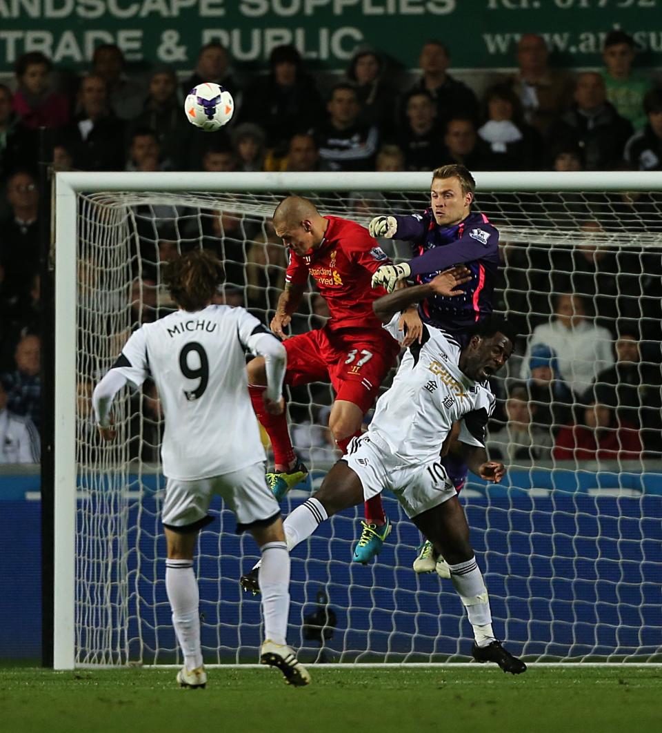 Liverpool's Simon Mignolet rises highest to punch the ball away