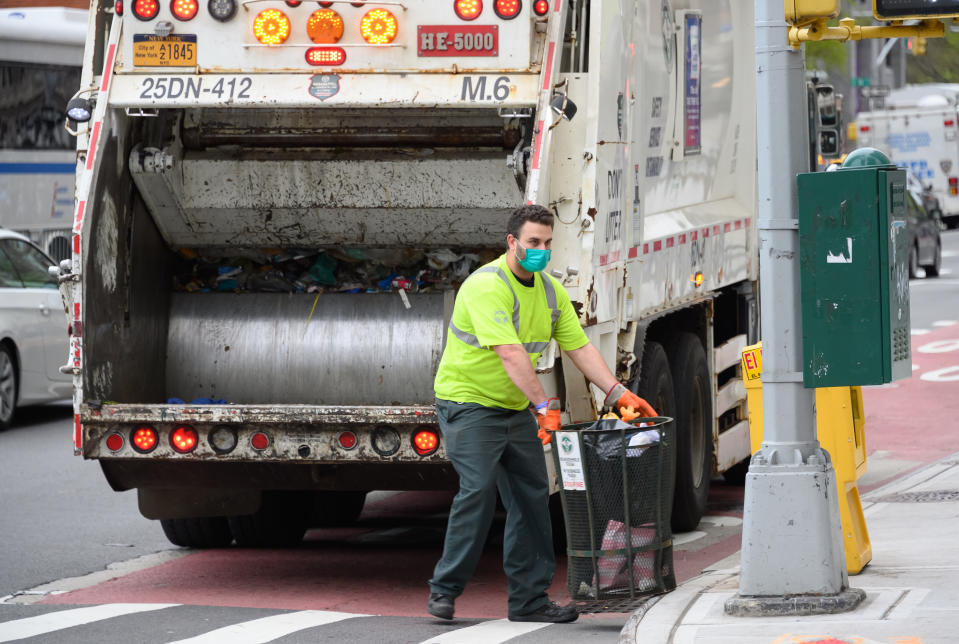 NEW YORK, NY - APRIL 14:  The NYC Department of Sanitation works during the coronavirus pandemic on April 14, 2020 in New York City. COVID-19 has spread to most countries around the world, claiming over 126,000 lives lost and over 1.9 million infections. (Photo by Noam Galai/Getty Images)