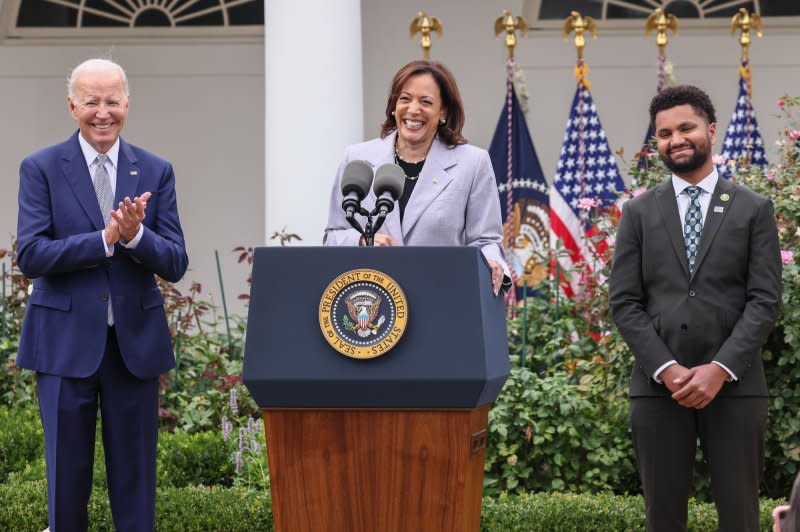 President Joe Biden (L) and Rep. Maxwell Frost, D-Fla. (R), listen as Vice President Kamala Harris talks about the effects of this nation's gun violence at a White House Rose Garden event in Washington on Friday. Photo by Jemal Countess/UPI