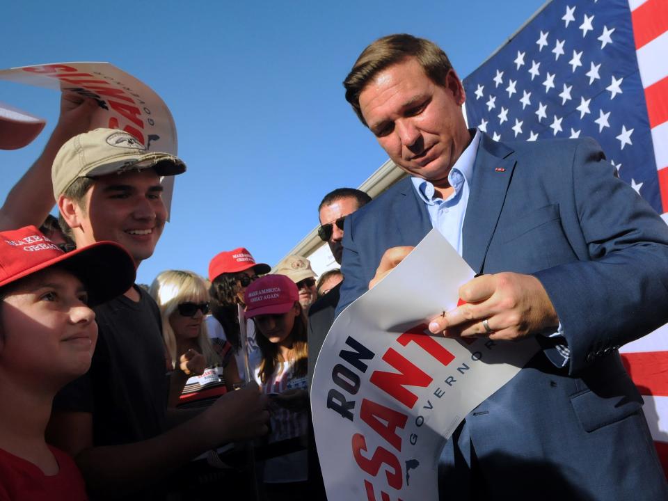 Florida GOP gubernatorial nominee Ron DeSantis signs an autograph for supporters after speaking at a rally outside a campaign office on October 28, 2018 in Melbourne, Florida.