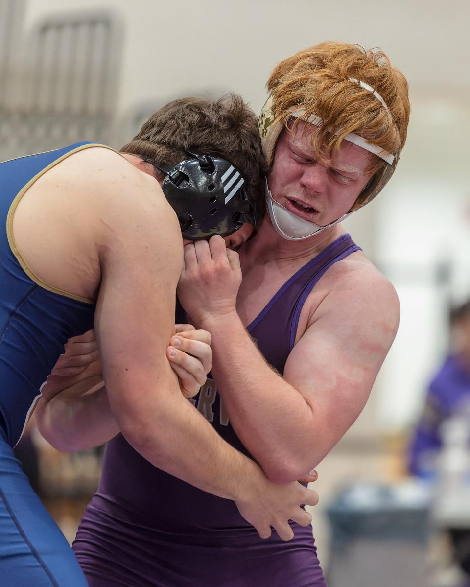 Fowlerville's Richard Davis (right) pinned Chelsea's Collin Tailford in the first match of the district final on Wednesday, Feb. 8, 2023.