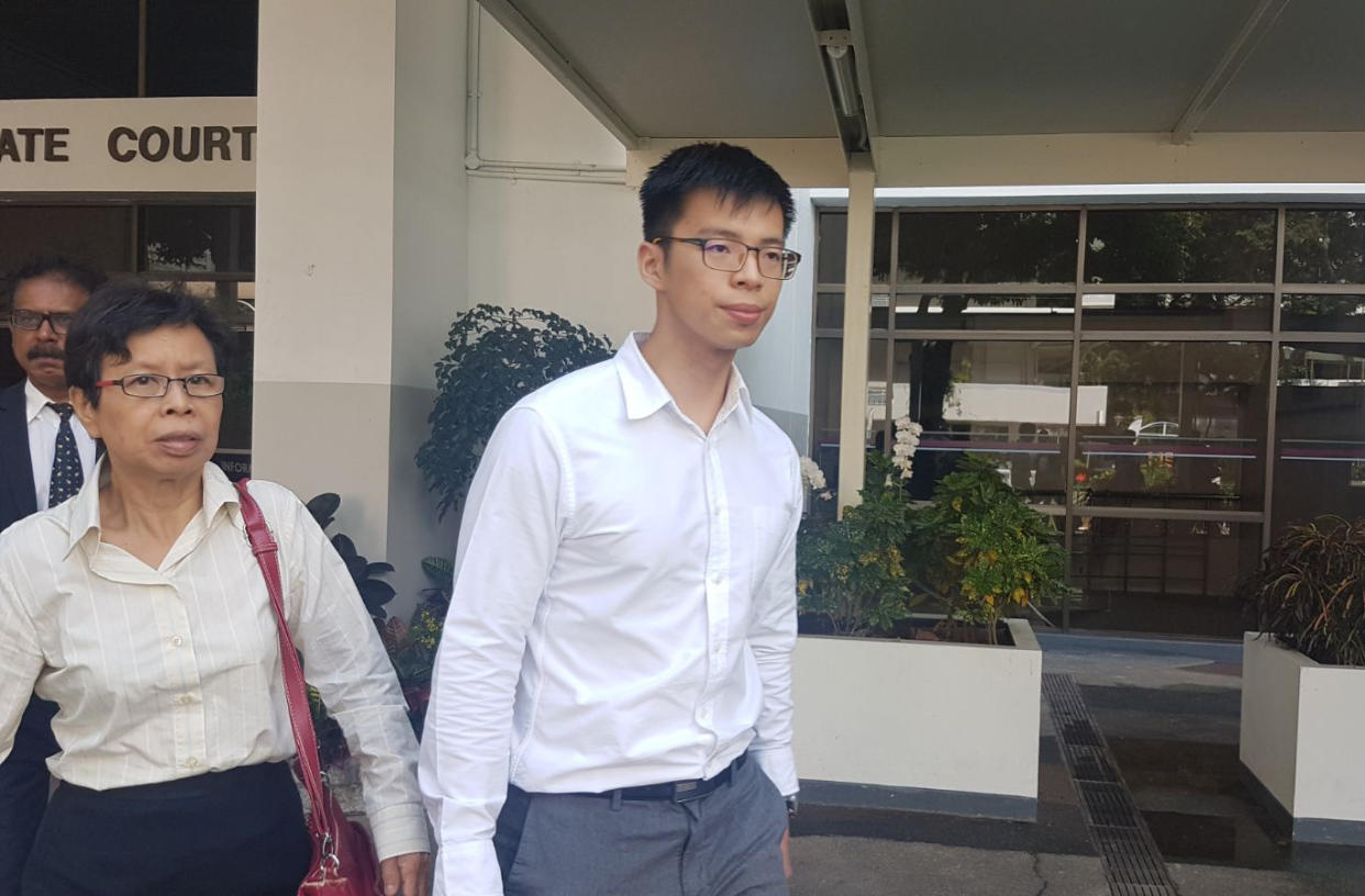 An HDB officer (right) was charged under the Official Secrets Act for giving confidential information to a Straits Times reporter. (Photo: Koh Wan Ting/Yahoo News Singapore)