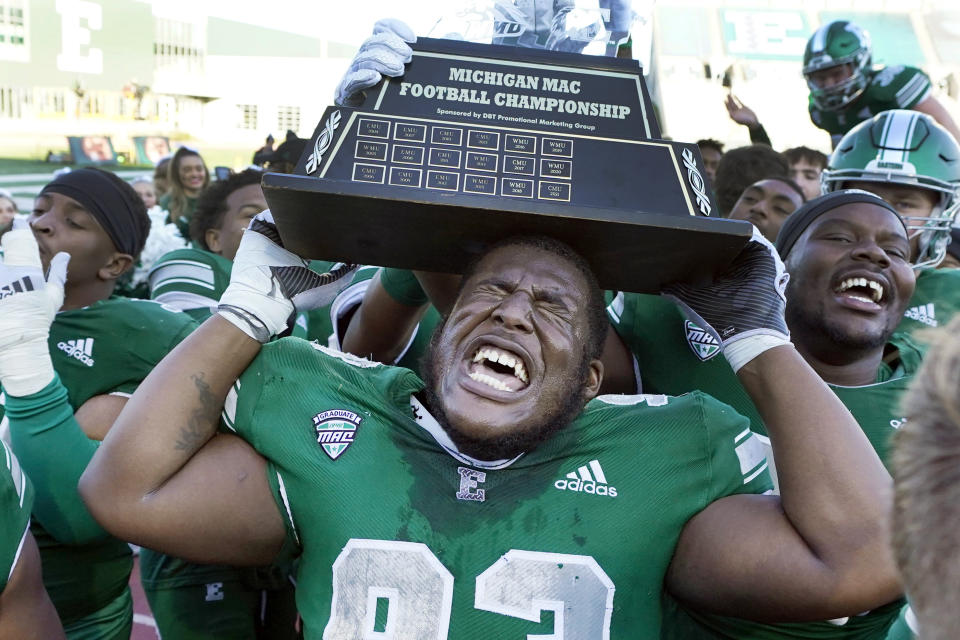 Eastern Michigan defensive lineman Jordan Crawford lifts the Michigan Mid-American Conference trophy after an NCAA college football game against Central Michigan, Friday, Nov. 25, 2022, in Ypsilanti, Mich. (AP Photo/Carlos Osorio)