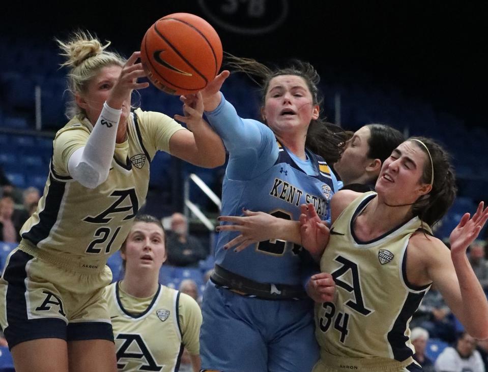 Akron's Molly Neitzel and Kent State's Clare Kelly vie for a rebound as KSU's Lindsey Thall and UA's Reagan Bass collide on the play Wednesday, Feb. 1, 2023.