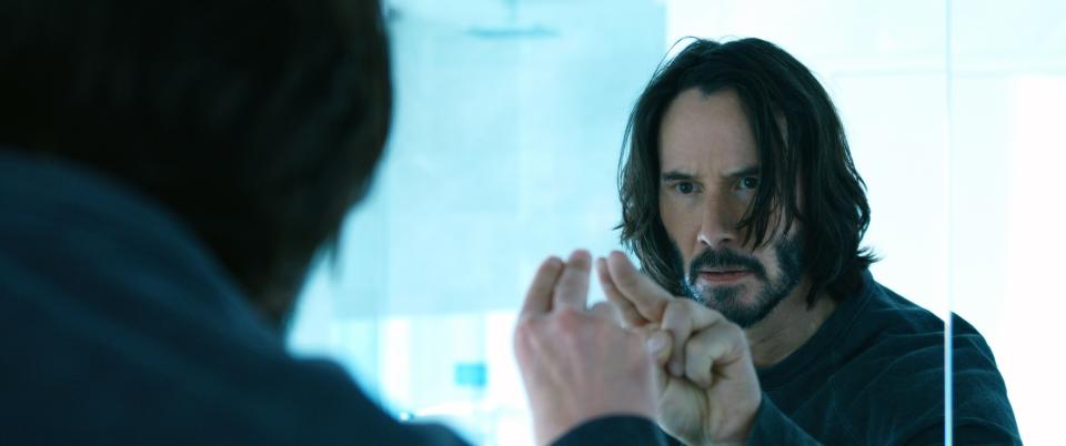 Keanu as Neo in front of a mirror