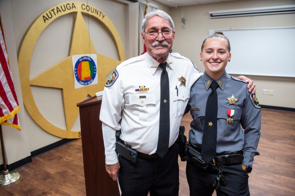 Sheriff Joe Sedinger presents a live saver award to Deputy Allie Livingston at the Autauga County Sheriff’s Office in Prattville, Ala., on Thursday, July 14, 2022.