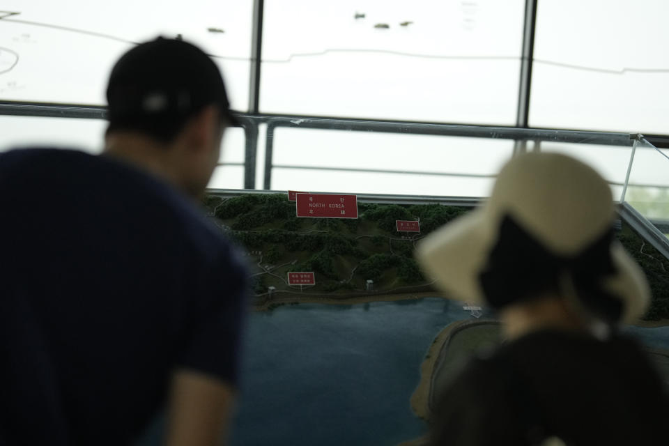 Visitors look at a map of two Koreas border area at the unification observatory in Paju, South Korea, Tuesday, June 11, 2024. South Korean soldiers fired warning shots after North Korean troops briefly violated the tense border earlier this week, South Korea's military said Tuesday, as the rivals are embroiled in Cold War-style campaigns like balloon launches and propaganda broadcasts.(AP Photo/Lee Jin-man)