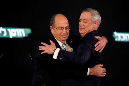 FILE PHOTO: Benny Gantz, a former Israeli armed forces chief and head of Israel Resilience party, hugs with former defence minister Moshe Yaalon during the party campaign launch in Tel Aviv, Israel January 29, 2019. REUTERS/Amir Cohen/File Photo