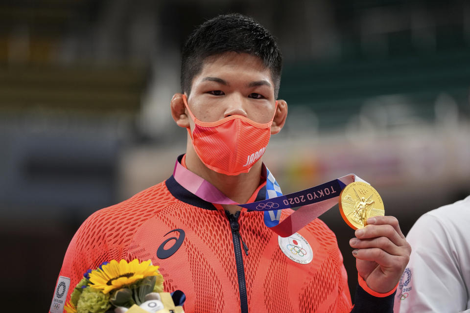 Gold medalist Shohei Ono of Japan poses after the medal ceremony for men's -73kg judo, at the 2020 Summer Olympics in Tokyo, Japan, Monday, July 26, 2021. (AP Photo/Vincent Thian)