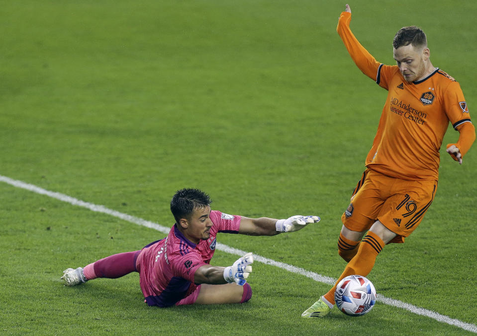 San Jose Earthquakes goalkeeper JT Marcinkowski (1) makes a save against Houston Dynamo FC forward Tyler Pasher (19) during the first half of an MLS soccer game at BBVA Stadium on Friday, April 16, 2021, in Houston. (Godofredo A. Vásquez/Houston Chronicle via AP)