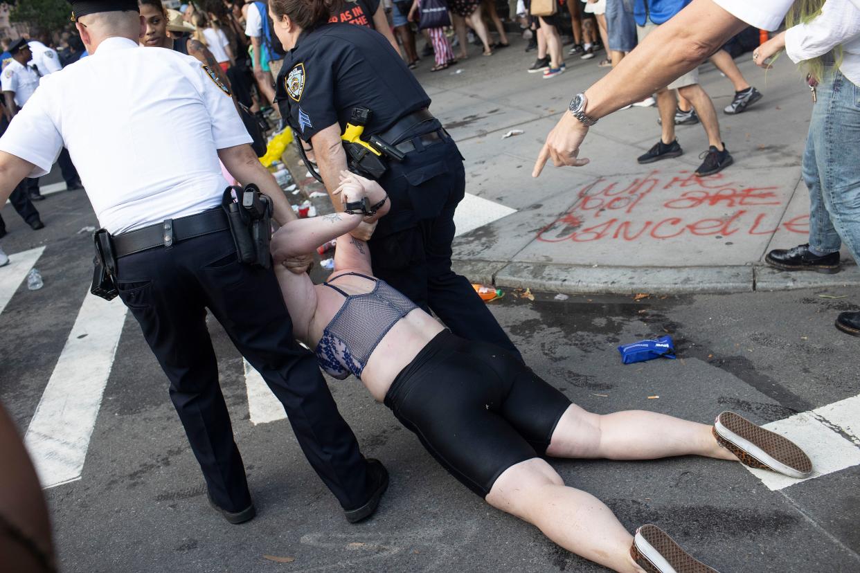 NYPD clash with revelers during Gay Pride festivities after trying to clear a street on the edge of Washington Square Park in the Greenwich Village neighborhood of Manhattan, New York.