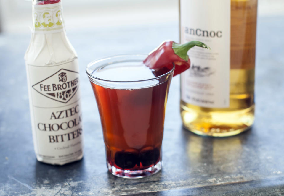 This Mar. 17, 2014 photo shows a Dark Night, a drink made with Aztec chocolate bitters, in Concord, N.H. (AP Photo/Matthew Mead)