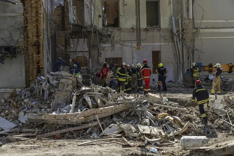 Rescue workers clear the rubble at the site of Okhmatdyt children's hospital hit by Russian missiles on Monday, in Kyiv, 9 July 2024