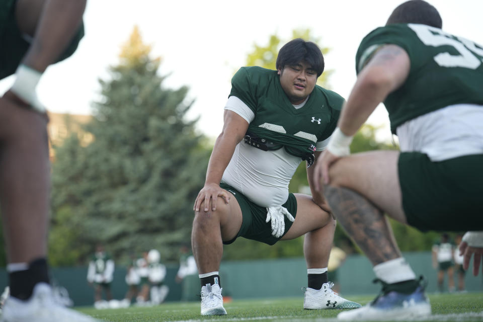 Colorado State defensive lineman Hidetora Hanada warms up takes part in drills during the team's NCAA college football practice on the university's campus Tuesday, Aug. 8, 2023, in Fort Collins, Colo. Back in Japan, the 6-foot-1, 280-pound Hanada rose to the highest amateur ranks of sumo wrestling by refusing to be pushed around in the ring. He's taking that same approach to the football field as he learns the ropes of being a run stuffer/pass rusher for the Rams. (AP Photo/Koji Ueda) (AP Photo/David Zalubowski)