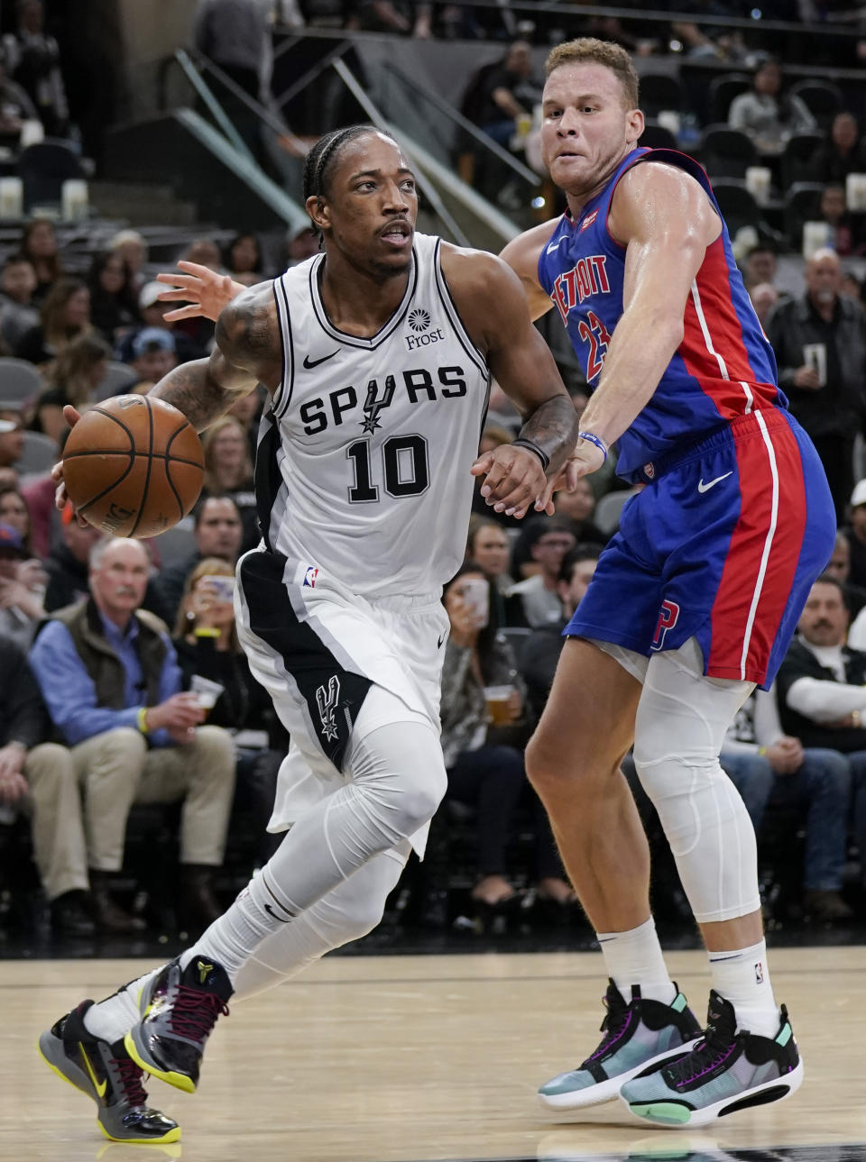 San Antonio Spurs' DeMar DeRozan (10) drives around Detroit Pistons' Blake Griffin during the second half of an NBA basketball game Saturday, Dec. 28, 2019, in San Antonio. San Antonio won 136-109. (AP Photo/Darren Abate)