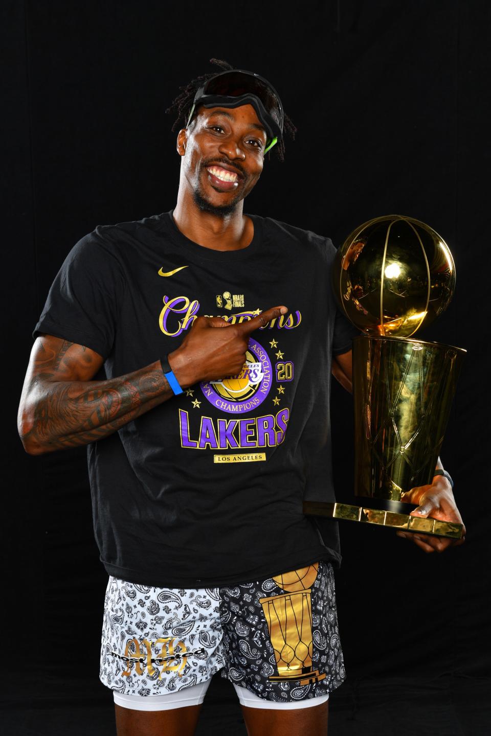 Dwight Howard with two trophies: the Larry O'Brien and his Most Hated shorts.