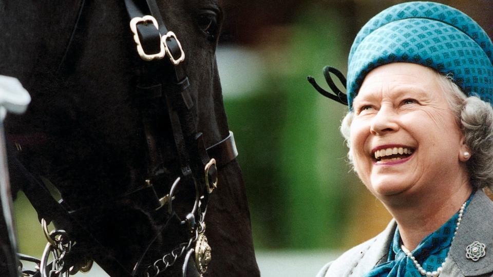 Queen Elizabeth Smiling looking at horse