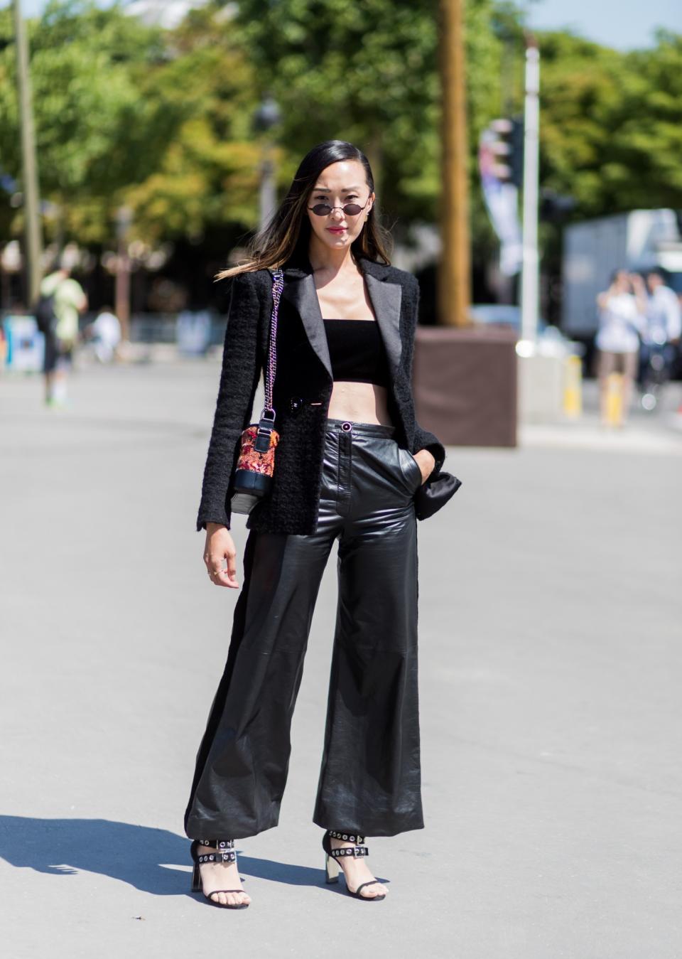 <p>Beauty blogger Chriselle Lim wears wide leg trousers, a black bandeau, blazer, and heels to Paris Haute Couture Fashion week. (Photo: Getty) </p>