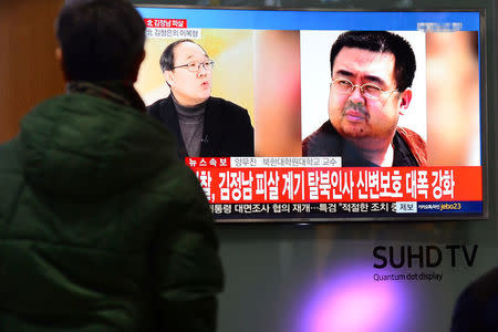 People watch a TV screen broadcasting a news report on the assassination of Kim Jong Nam, the older half brother of the North Korean leader Kim Jong Un, at a railway station in Seoul, South Korea, February 14, 2017. Lim Se-young/News1 via REUTERS