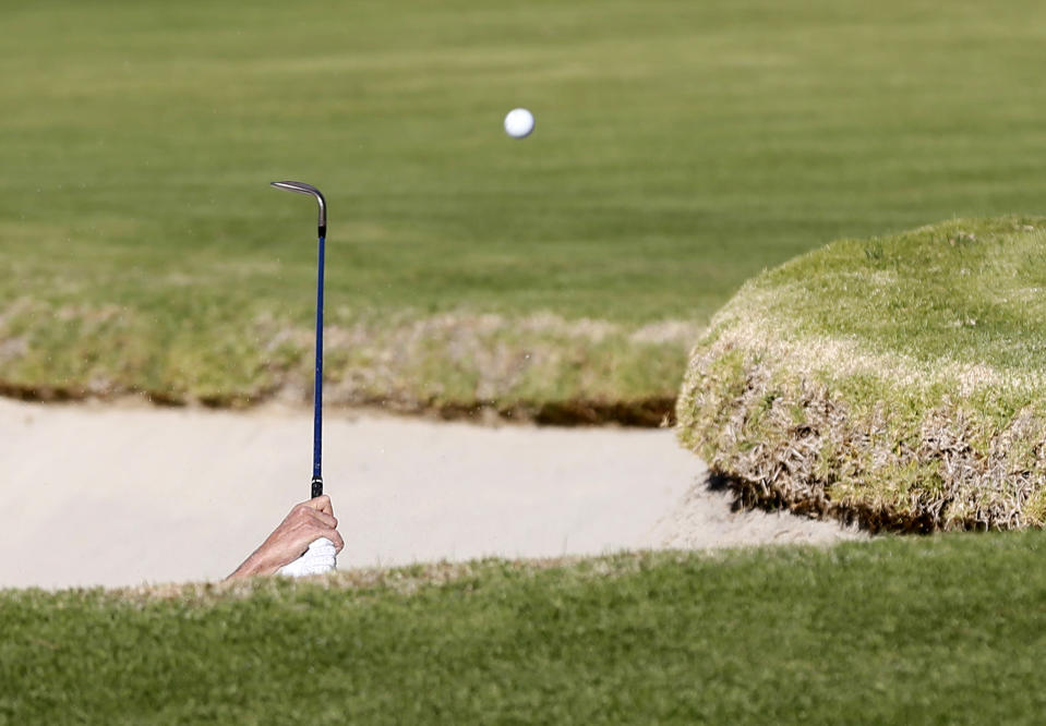 Adam Scott of Australia hits out of a deep bunker onto the first green during the third round of the Northern Trust Open golf tournament at Riviera Country Club in Los Angeles February 16, 2013. REUTERS/Danny Moloshok (UNITED STATES - Tags: SPORT GOLF) - RTR3DVW1