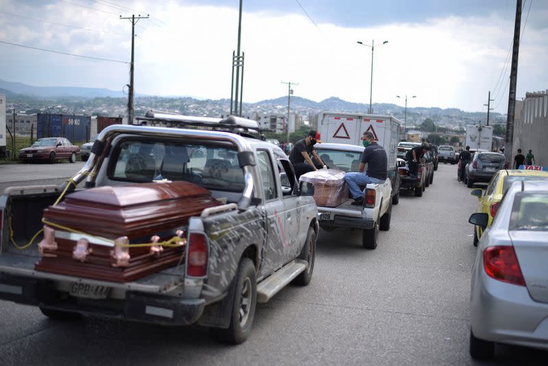 Vehicles carrying coffins are lined up outside of a cemetery as Ecuador's government announced on Thursday it was building a "special camp" in Guayaquil for coronavirus disease (COVID-19) victims, in Guayaquil