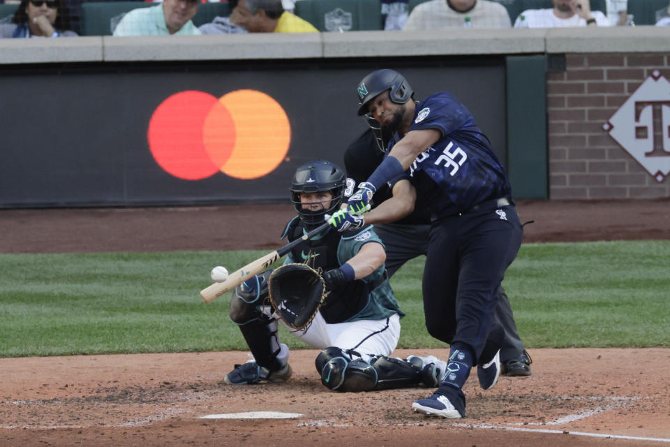 National League's Elias Díaz, of the Colorado Rockies (35), hits a two run home run in the eighth inning during the MLB All-Star baseball game in Seattle, Tuesday, July 11, 2023. (AP Photo/John Froschauer)