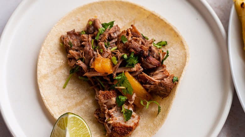 Tender al pastor on tortilla