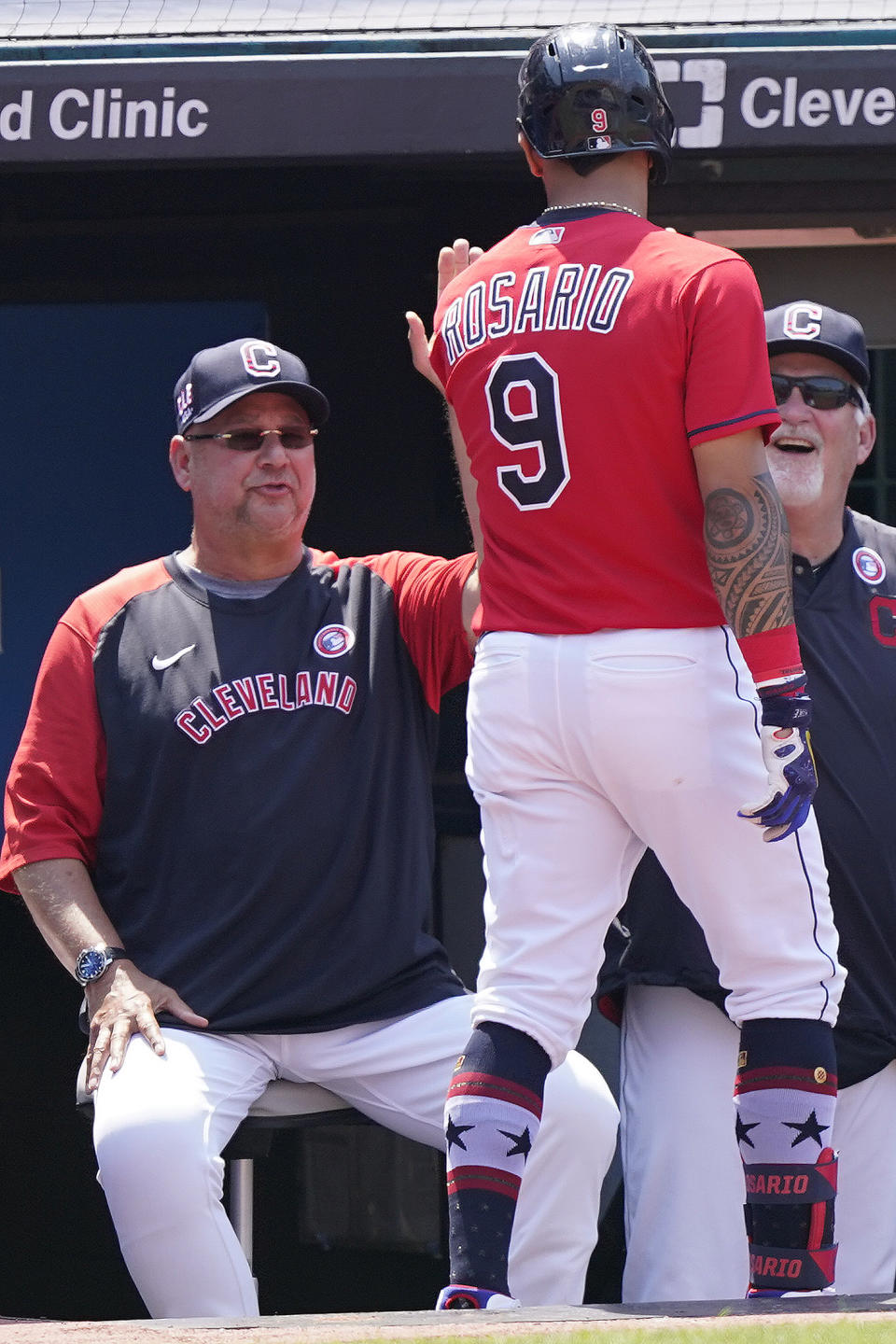 Cleveland Indians' Eddie Rosario, right, is congratulated by manager Terry Francona, left, after hitting a solo home run in the sixth inning of a baseball game against the Houston Astros, Sunday, July 4, 2021, in Cleveland. (AP Photo/Tony Dejak)