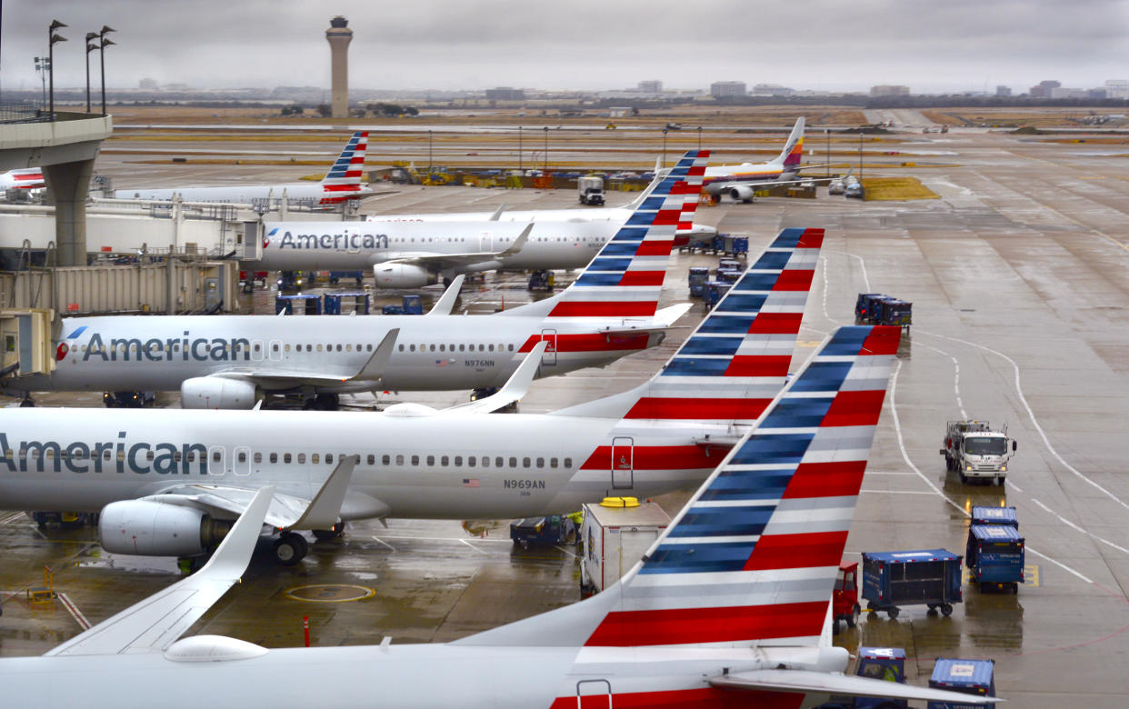 DALLAS, TEXAS - DECEMBER 8, 2018: American Airlines passenger jets parked at their gates on a rainy morning at Dallas/Fort Worth International Airport which serves the Dallas/Fort Worth, Texas, metroplex area in Texas. (Photo by Robert Alexander/Getty Images)