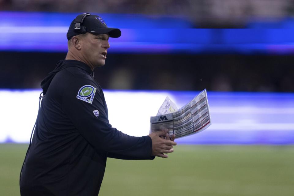 Washington coach Kalen DeBoer gestures from the sideline.