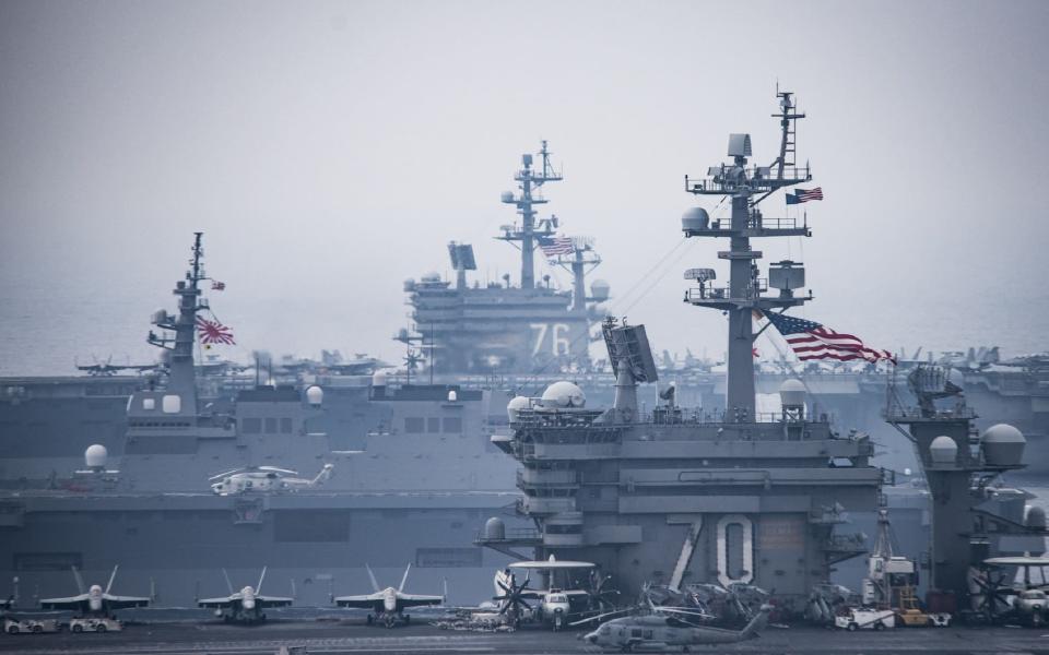 This US Navy handout photo shows the Carl Vinson Carrier Strike Group, operating with the Ronald Reagan Carrier Strike Group, which includes the USS Shiloh - Credit: AFP