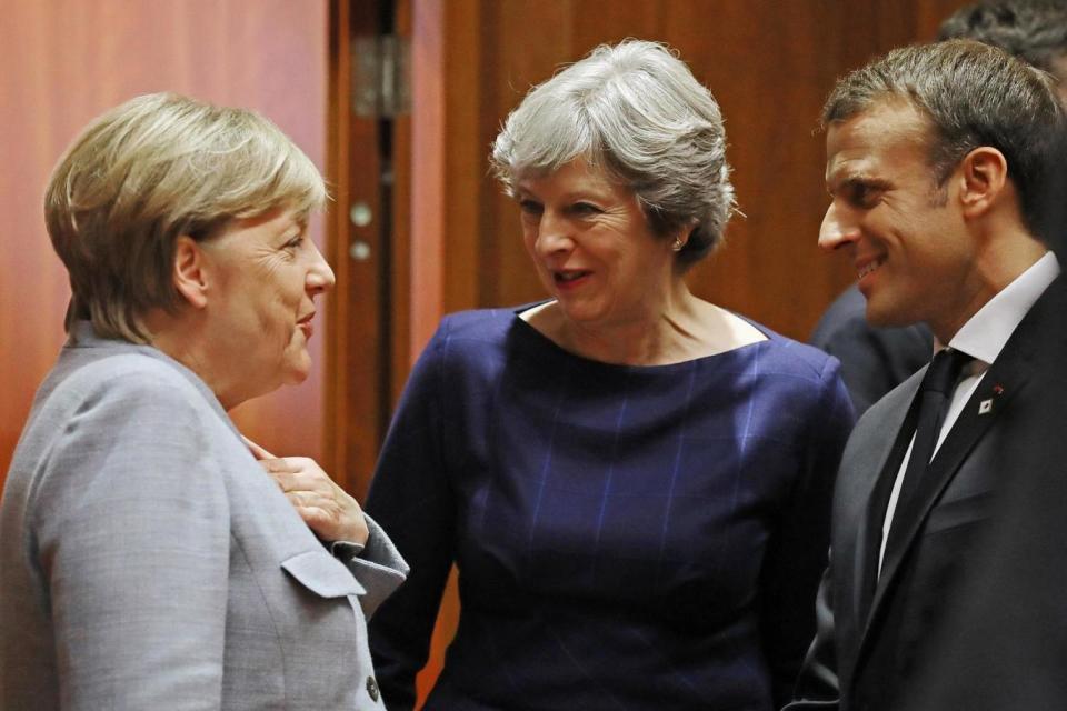 Talks: Chancellor Angela Merkel, Theresa May and President Emmanuel Macron laugh together at the EU Summit (Getty Images)