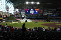 A fan waits for a fly ball during batting practice before Game 2 of baseball's World Series between the Houston Astros and the Atlanta Braves Wednesday, Oct. 27, 2021, in Houston. (AP Photo/Ashley Landis)