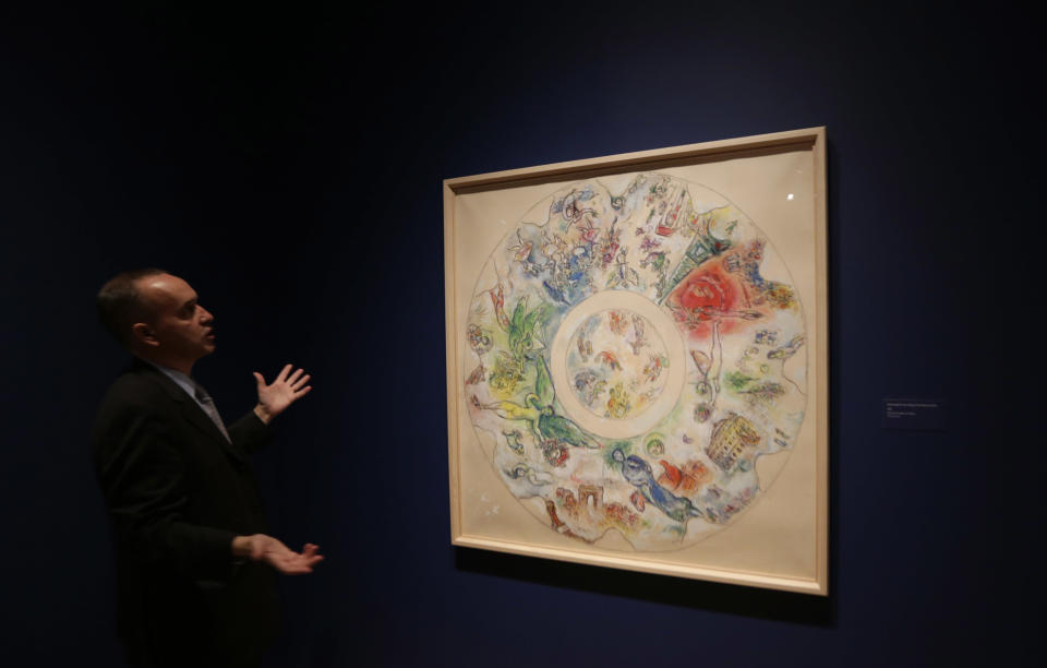 In this photo taken Feb. 13, 2013 Museum curator Olivier Meslay talks about a 1963 Marc Chagall piece titled "Final study for the ceiling of the opera Garnier," included in the "Chagall: Beyond Color," exhibit during a preview at the Dallas Museum of Art in Dallas. This will be the only U.S. venue to host the exhibit that opens to the public on Sunday. (AP Photo/LM Otero)