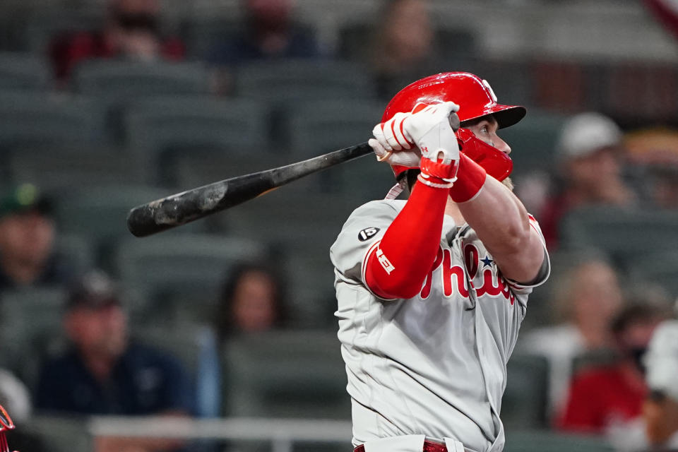 Philadelphia Phillies' Bryce Harper (3) follows through on a home run in the sixth inning of a baseball game against the Atlanta Braves, Sunday, April 11, 2021, in Atlanta. (AP Photo/John Bazemore)