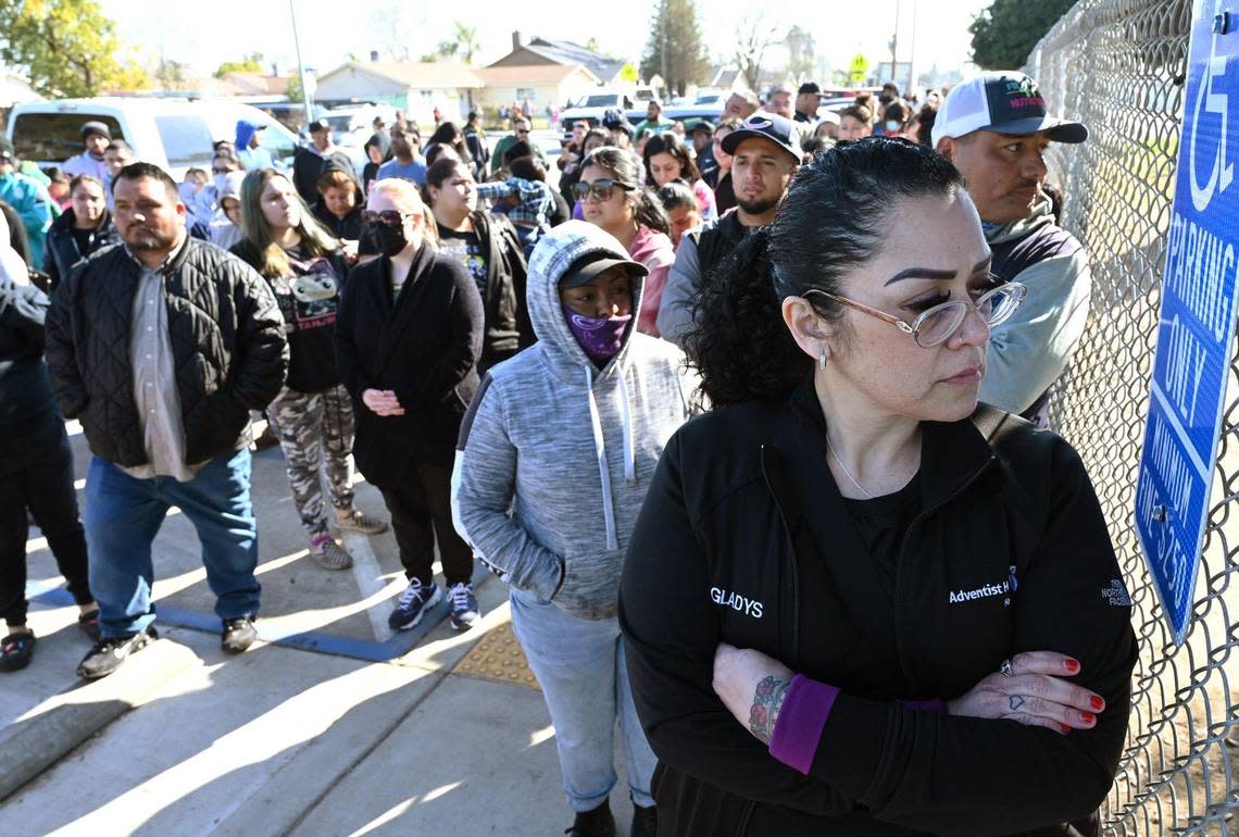 Gladys Resendez, right, peers through the fencing at Eric White Elementary School waiting for her 10 year old to be released as she and hundreds of other parents waited after the school was locked down following a shooting incident Tuesday, Jan. 31, 2023 in Selma.