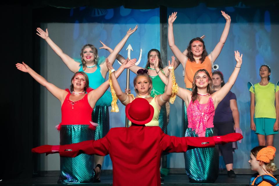 Sebastian, played by Josiah Cutlip (center), direct the sisters of Ariel during a rehearsal for "The Little Mermaid Jr." at the Cambridge Performing Arts Center. The production opens Friday.