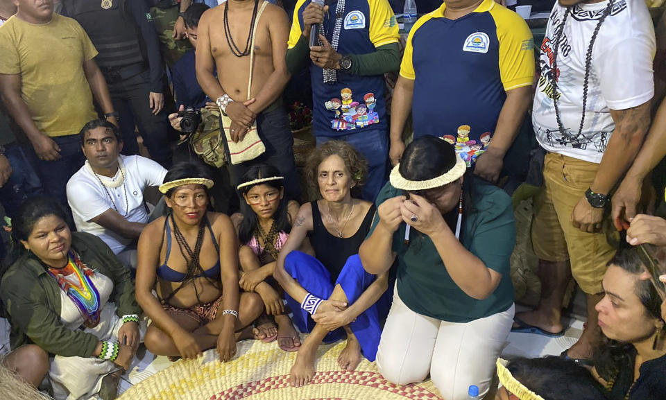 Alessandra Sampaio, widow of British journalist Dom Phillips, third right, Beatriz Matos, widow of Indigenous expert Bruno Pereira, right, Sonia Guajajara, Brazil's first Minister of Indigenous Peoples, left, and Joenia Wapichana, President of the National Foundation for Indigenous People, second right, attend a ceremony in Atalaia do Norte, Vale do Javari, Amazonas state, Brazil, Monday, Feb. 27, 2023. In a symbolic gesture, a high-level delegation from the Brazilian government paid a visit on Monday to the region where the Indigenous expert Bruno Pereira and British journalist Dom Phillips were murdered last year. (AP Photo/Fabiano Maisonnave)